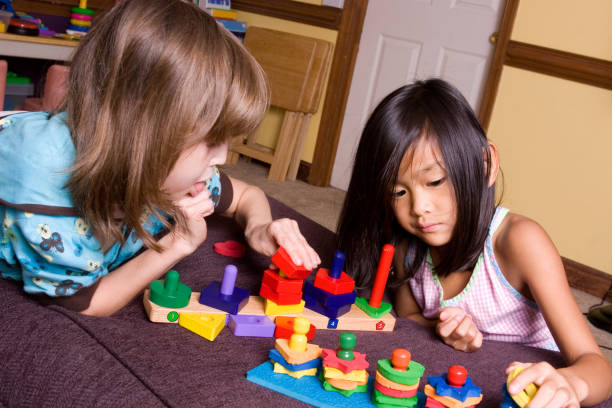 A wooden shape sorter puzzle with a triangle, circle, square and rectangle