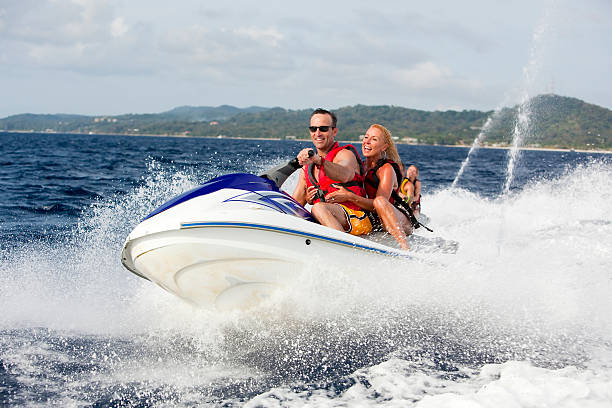 istock Happy couple ridding jetski 157433786