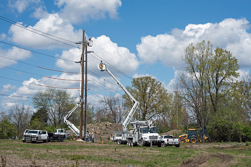 Electrical crew begin work on replacing old electrical utility pole with a new one.