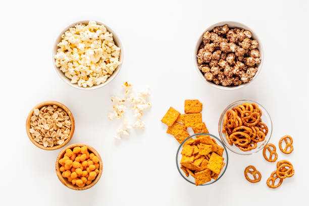 istock Many bowls of snacks for party - chips popcorn and nuts 1574340157