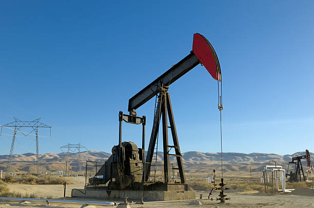 istock Oil Pumpjack with Electrical Pylons in Background 157434156