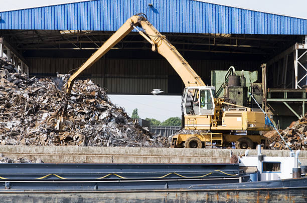 Tugboat is pulling a barge with scrap metal along the  Newtown Creek in Greenpoint, Brooklyn, New York.