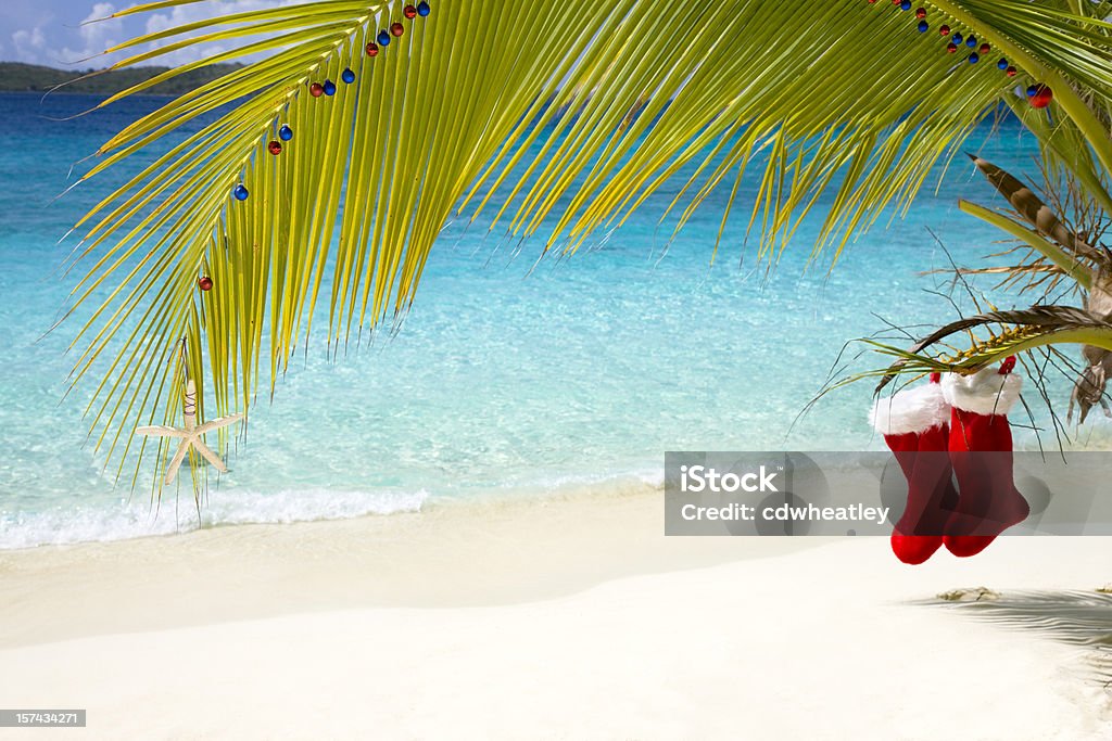 tropical Christmas in the Caribbean tropical Christmas on the beach in the Caribbean with two Santa Claus stockings Christmas Stock Photo