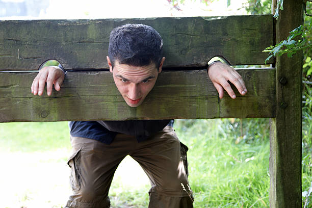 istock Man in medieval stocks 157434369