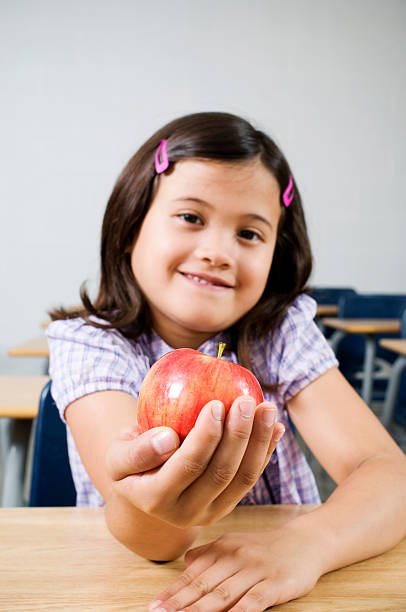 istock School Girl with Apple 157434523