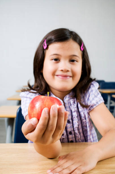 istock School Girl with Apple 157434524