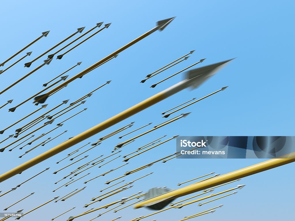 Many blurred arrows in motion flying through clear blue sky A barrage of arrows in flight against a blue sky. Very detailed high resolution 3D render. Arrow - Bow and Arrow Stock Photo