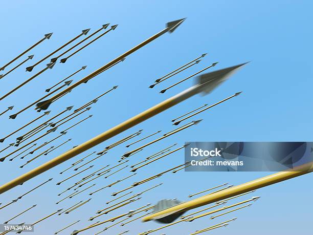Many Blurred Arrows In Motion Flying Through Clear Blue Sky Stock Photo - Download Image Now