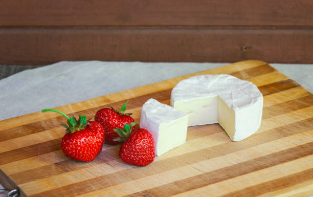 istock Camembert cheese with  strawberries. Selective focus. 1574348126