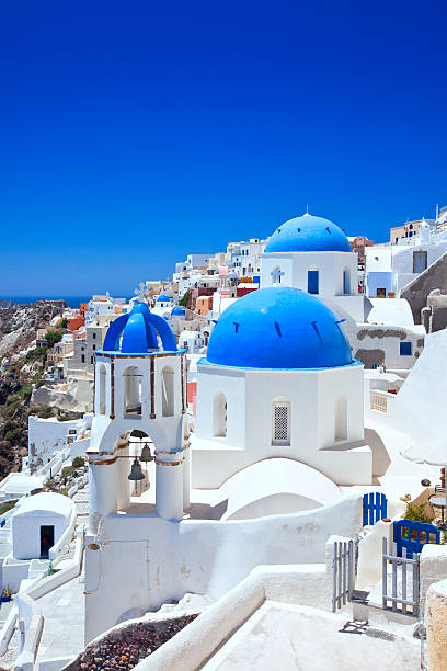 Santorini famous churches Famous Orthodox church with blue domes in village Oia (Ia) on Santorini island. Click for more images: aegean sea photos stock pictures, royalty-free photos & images