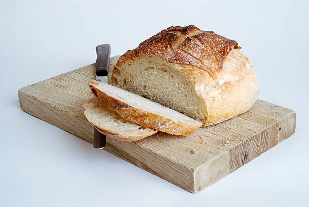 Sliced Round Loaf of Bread on a Cutting Board stock photo