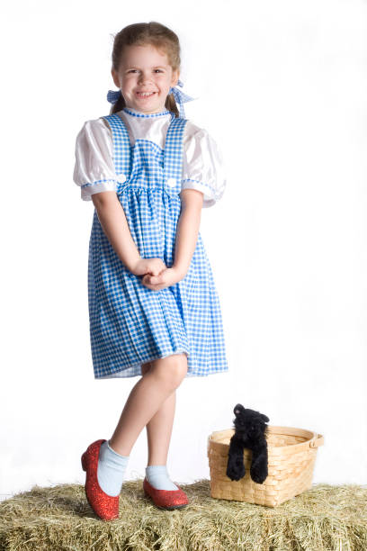 Dutch cheese girl in a red dress and clogs; Gouda, Netherlands