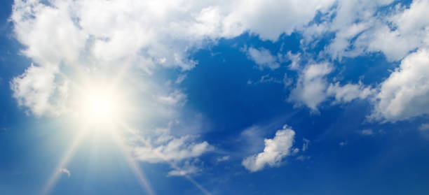 istock Bright sun, blue sky and clouds. Wide photo. 1574364085