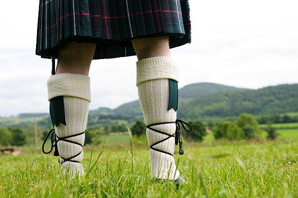 Scottish Kilt and Stockings A Scotsman wearing a kilt, facing the hills of Perthshire. kilt stock pictures, royalty-free photos & images