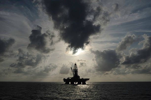 istock Distant offshore oil rig with skyscape 157436542