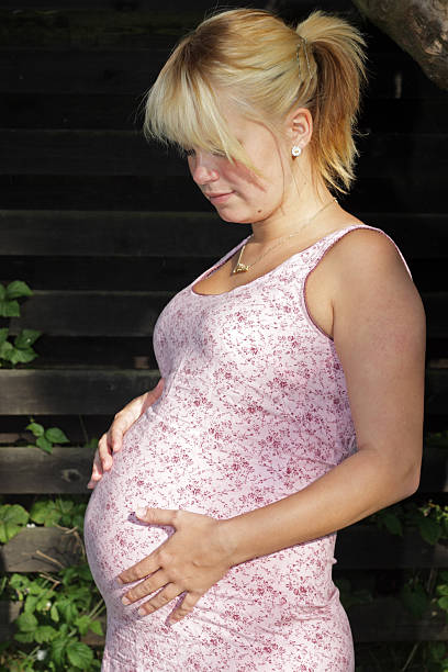 妊娠若い女の子ふさぎこむ - teenage pregnancy human pregnancy abdomen women ストックフォトと画像