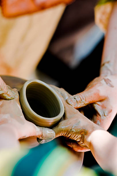istock potter makes a jug out of clay 157436748