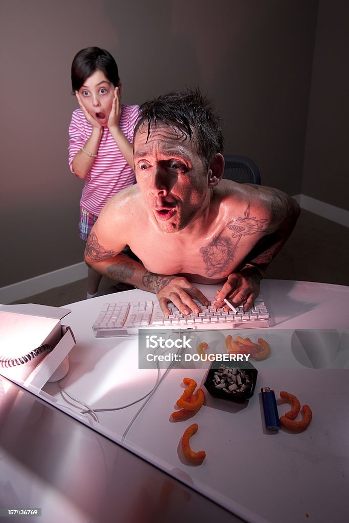 Dad caught surfing adult web site daughter shocked by what father is looking at on his computer, red and blue gels employed to create drama. Security Stock Photo