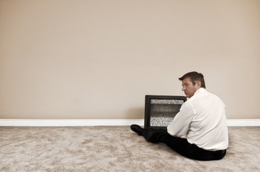 No cable. No furniture. This businessman is facing some tough times.  iStockalypse HQ.
