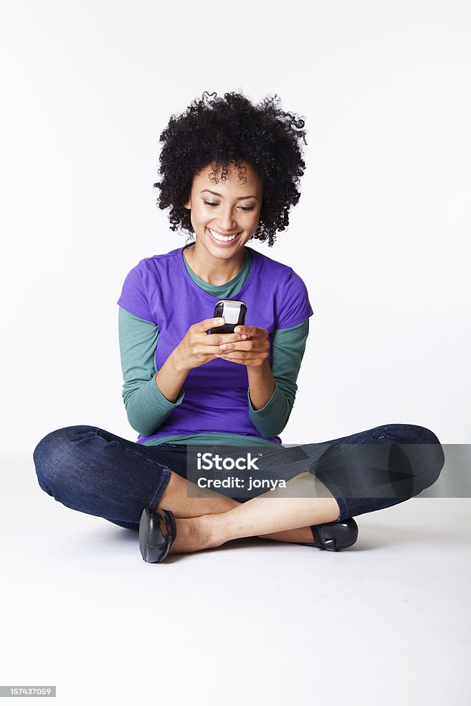 pretty girl text messaging  African Ethnicity Stock Photo