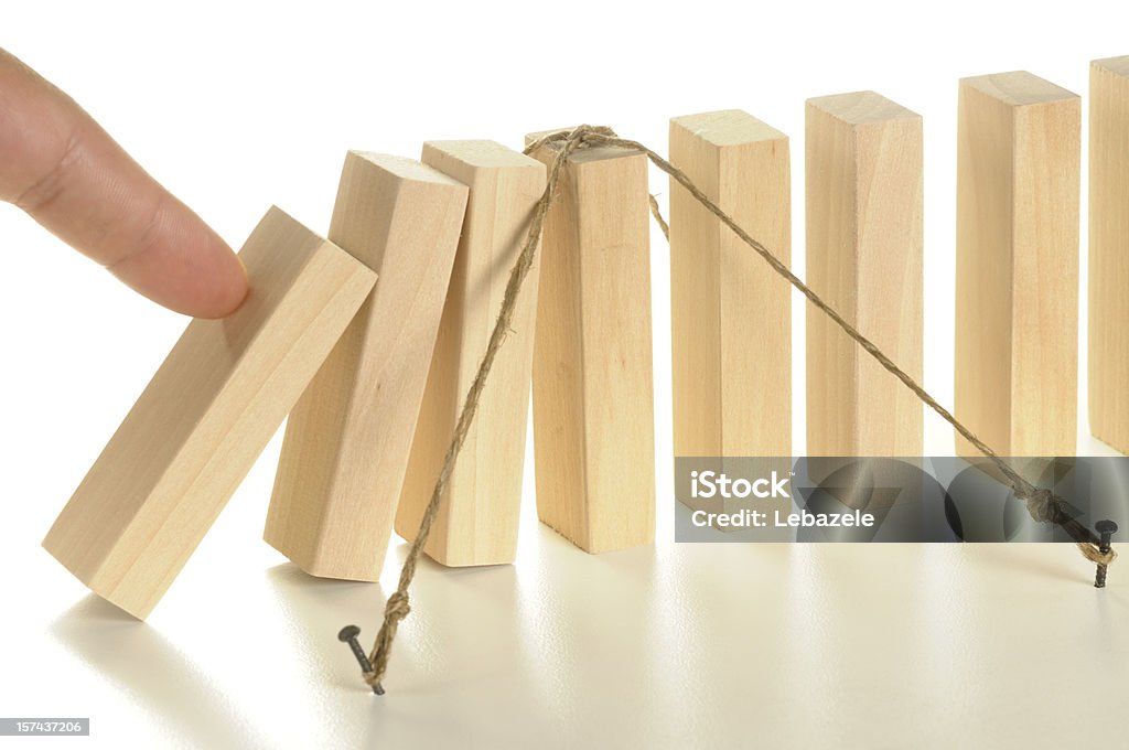 Illustration using tethered wooden dominos for insurance Insurance, business concept. Risk Stock Photo