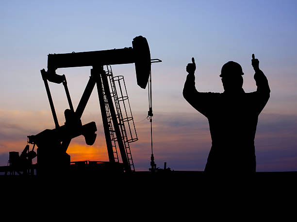 Oil Industry Pumpjack & Workers  oil pump oil industry alberta equipment stock pictures, royalty-free photos & images