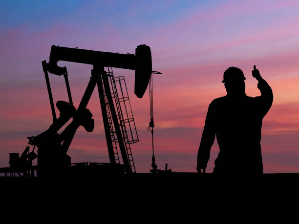 istock Pumpjack Silhouette with Oil Worker 157437679