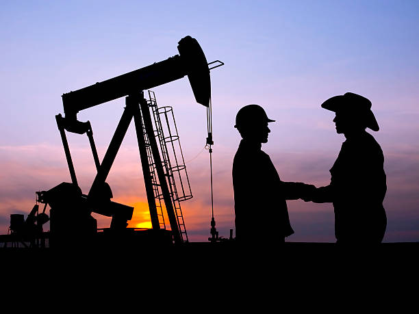 istock Oil Worker and Rancher Farmer Cooperating at Pumpjack 157437814
