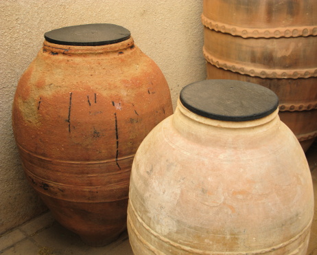 Three southwestern terracotta water jugs.