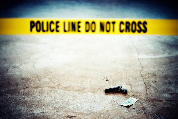 Crime scene Crime scene with blood, gun and Police line do not cross belt. Taken on Uber'lpse Berlin 2009. bloody money stock pictures, royalty-free photos & images