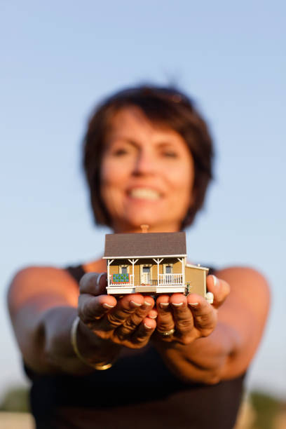 Female Hands holding house Female hands holding house for sale sign information sign information symbol stock pictures, royalty-free photos & images