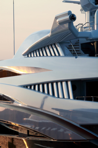 the close up side view of a futuristic super yacht in French port at sunset. subtle colours and interesting shapes, curves and lines. Please see my other Super Yacht side photos...
