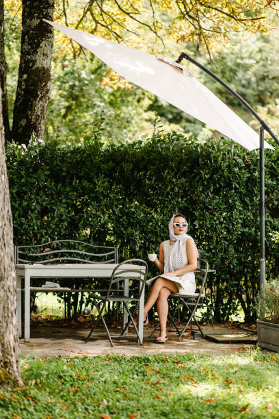 istock Drinking morning coffee in a yard 1574388164