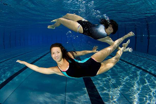 istock Female swimmers posing underwater 157438888