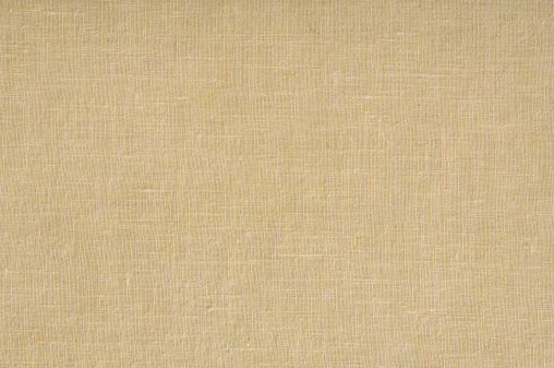 Hessian sackcloth background, beige craft color. Natural burlap canvas closeup