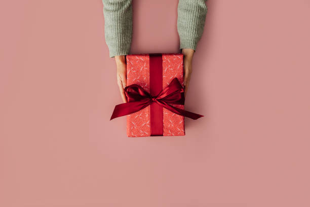 istock Birthday Surprise: A Gift Wrapped In A Red Wrapping Paper Ready To Be Delivered 1574391353