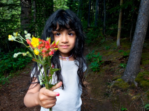 Adorable little girl offering a bouquet of freshly-picked wildflowers. Shot at HQLypse09. 
