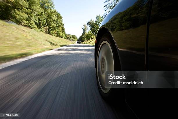 Outside View Of A Car Driving Down The Street Stock Photo - Download Image Now - Tire - Vehicle Part, Car, Road