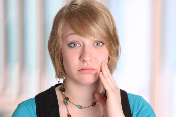 Young woman gesturing toothache