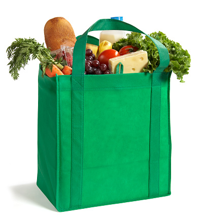 A reusable/recyclable grocery bag filled with fresh groceries. Be Green!