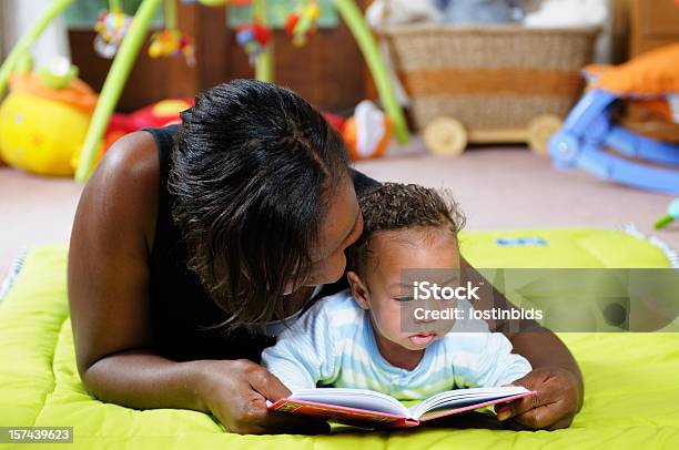 Storytime On The Playmat With Mother And Baby Stock Photo - Download Image Now - Baby - Human Age, Talking, Learning
