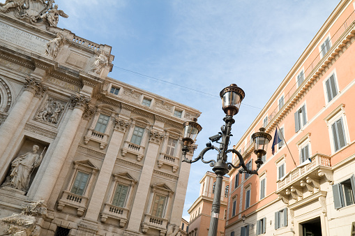 Angled view of a Roman street and lamp post.