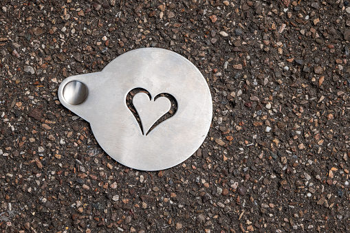 a metal plate with a decorative heart with view from above