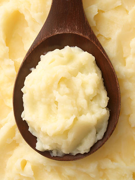 Potato puree Top view of wooden spoon full of potato puree mashed potatoes stock pictures, royalty-free photos & images