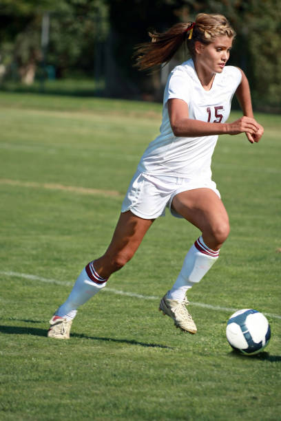 istock Female Soccer Player Pounces on a Dribble with copyspace 157440035