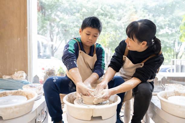 istock A woman and a little boy are making handmade pottery 1574400859