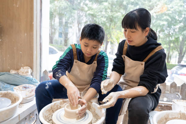 A woman and a little boy are making handmade pottery
