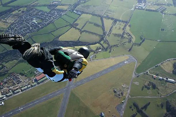 Photo of Skydiver free falling above countryside