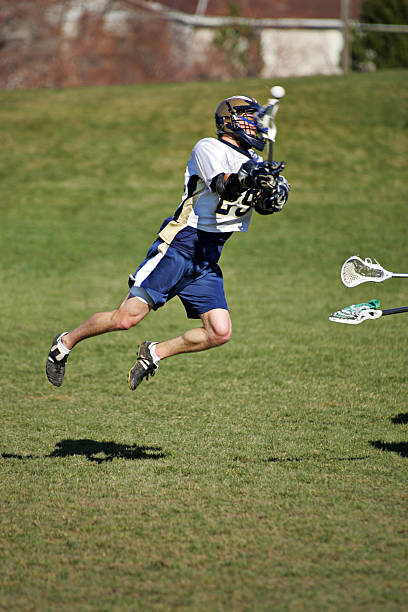 istock Young Lacrosse Player Jumps and Shoots with copy space 157440908