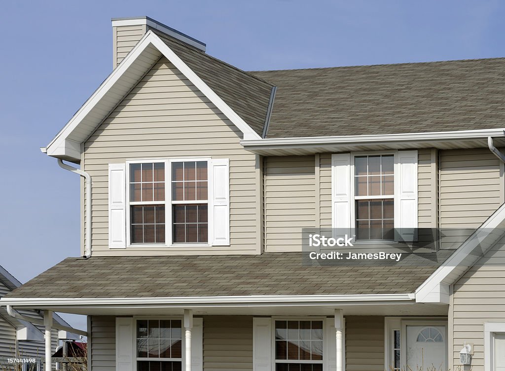 Residential Home With Vinyl Siding, Gable Roof, Seamless Gutters, Shutters If you require a shot of a new home or any of the array of building products shown, this would be a great image for you. It shows, architectural asphalt shingle roof, vinyl siding, windows, vinyl shutters, seamless aluminum gutters. Siding - Building Feature Stock Photo
